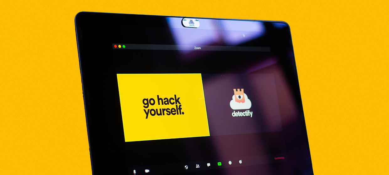 A graphic of the Detectify logo and 'go hack yourself' slogan on a Zoom screen